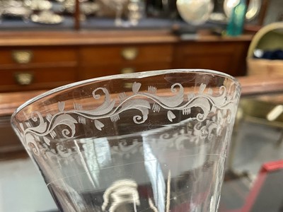 Lot 22 - Pair of light baluster wine glasses, circa 1730, with tapering funnel bowls, knopped and cushioned baluster stems with tear-drop, on a conical foot, the rim engraved with a band of scrolling f...