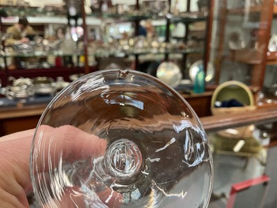 Lot 22 - Pair of light baluster wine glasses, circa 1730, with tapering funnel bowls, knopped and cushioned baluster stems with tear-drop, on a conical foot, the rim engraved with a band of scrolling f...