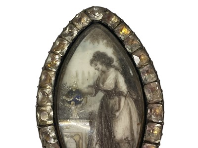 Lot 450 - George III mourning brooch of navette form, the ivory plaque painted in sepia depicting a lady standing by a gold and seed pearl urn on pedestal