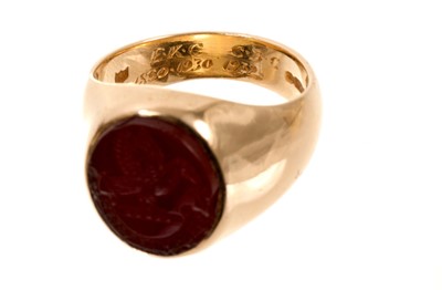 Lot 457 - Gold signet ring with an oval intaglio carved carnelian depicting a family crest and motto (London 1977). Ring size N-N½