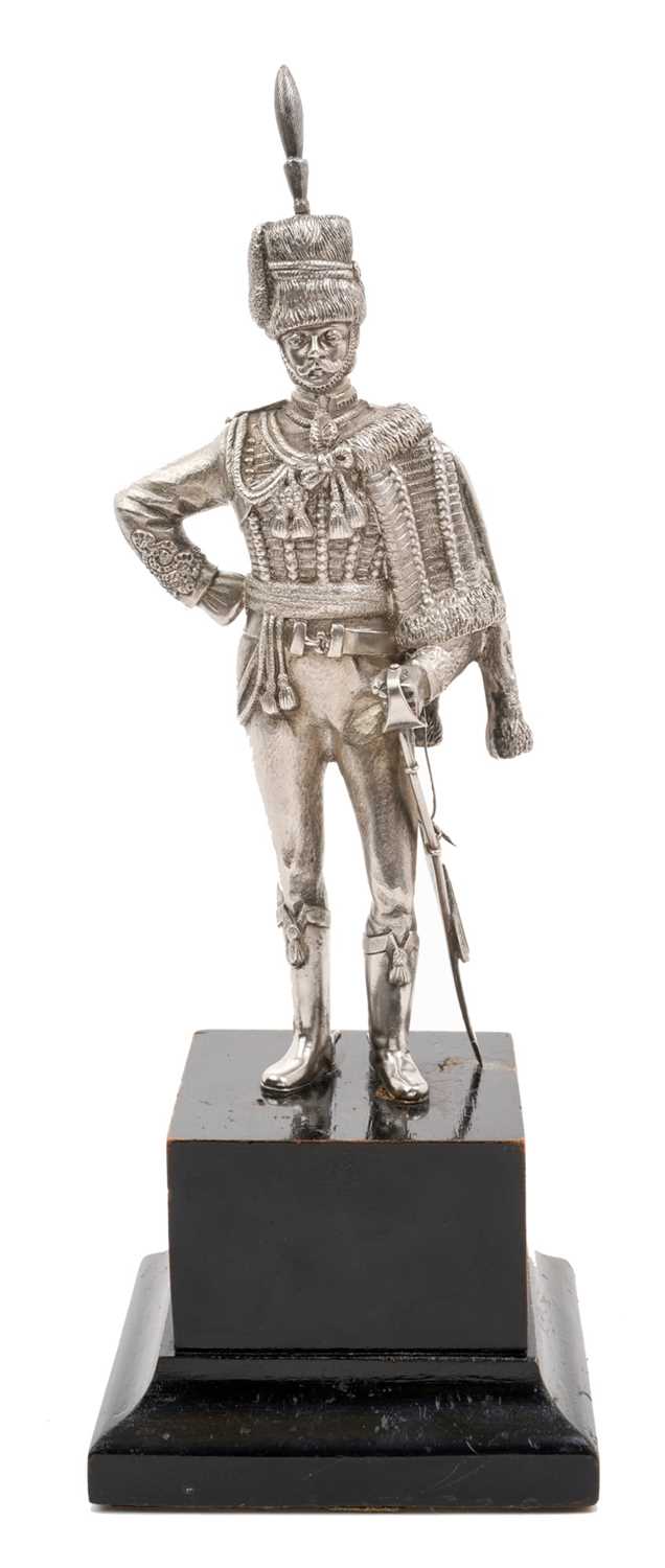 Lot 117 - Good quality 20th century silver model of a Hussar Officer in full dress, with sword, mounted on an ebonised wood plinth (London Assay marks only, no date letter or maker visible).