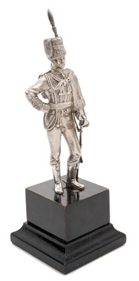 Lot 117 - Good quality 20th century silver model of a Hussar Officer in full dress, with sword, mounted on an ebonised wood plinth (London Assay marks only, no date letter or maker visible).
