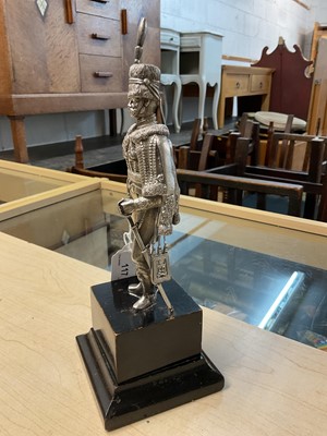 Lot 117 - Good quality 20th century silver model of a Hussar Officer in full dress, with sword, mounted on an ebonised wood plinth (London Assay marks only, no date letter or maker visible).