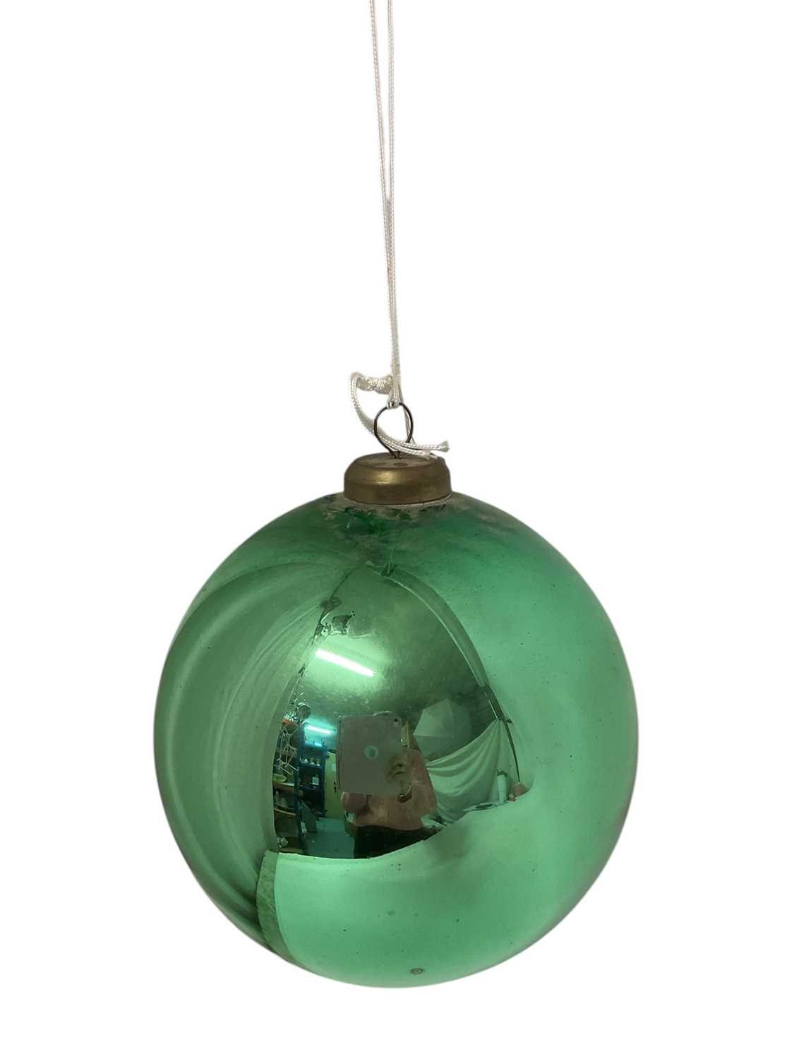 Lot 798 - Green glass witch ball, with suspension loop, approximately 23cm diameter