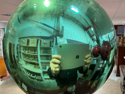 Lot 798 - Green glass witch ball, with suspension loop, approximately 23cm diameter