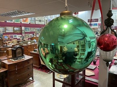 Lot 798 - Green glass witch ball, with suspension loop, approximately 23cm diameter