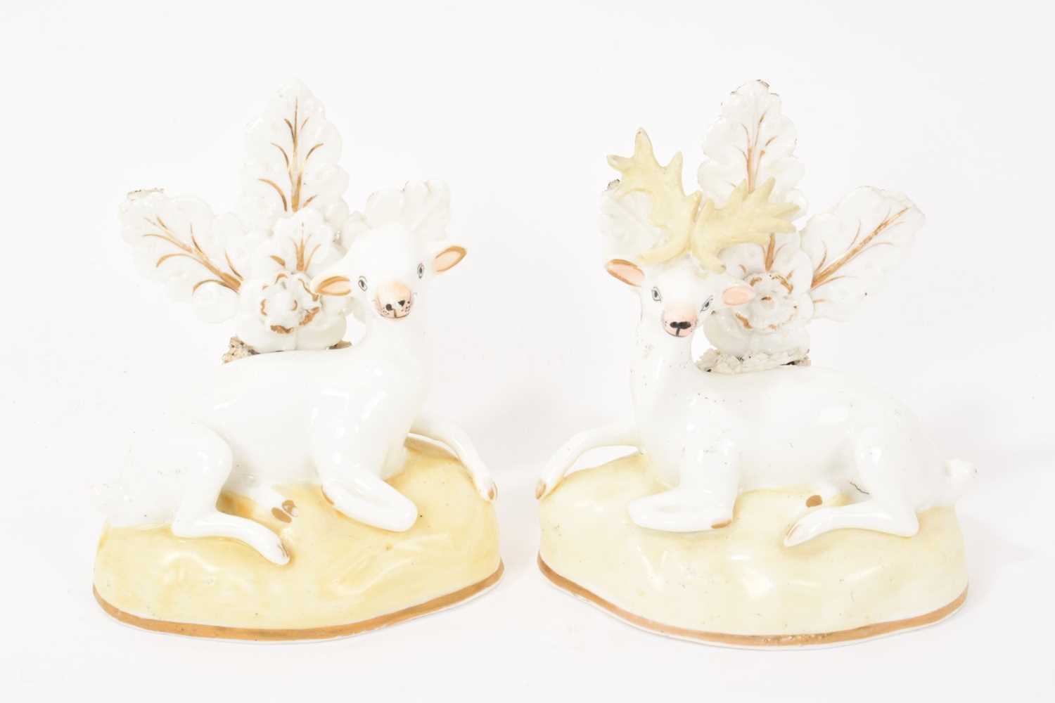Lot 123 - Pair of Samuel Alcock porcelain figures of a doe and stag, circa 1830, sparsely decorated, shown seated on gilt-lined bases, 11.5cm high
