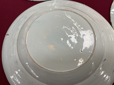 Lot 3 - Set of four 18th century Delft plates, polychrome painted in the Chinese style with a figure on a bridge near a pagoda, 23cm diameter
