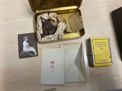 Lot 49 - First World War Princess Mary Gift Tin with original tobacco packet, Christmas card and photograph of Princess Mary. Together with pieces of shrapnel with annotation "HSB, bits of shell which bu...
