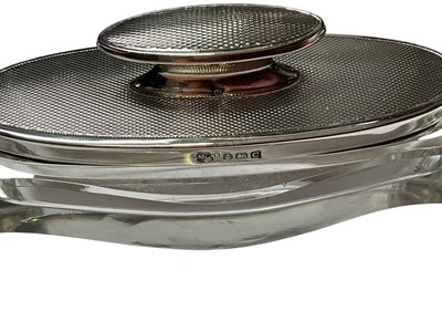 Lot 21 - Mappin & Webb silver jewellery box, matching silver backed dressing table mirror and silver mounted manicure set
