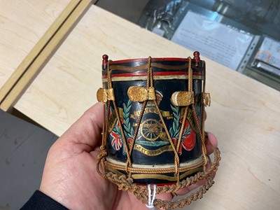 Lot 123 - Good quality early 20th century miniature Royal Artillery regimental drum with hand painted regimental badge and flags,7.9cm in overall height.