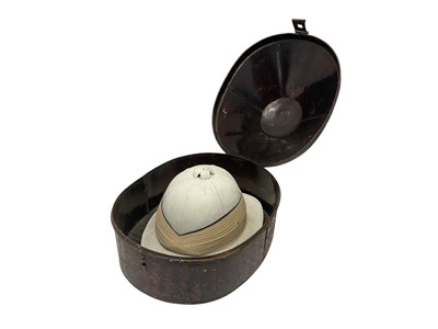 Lot 112 - Early 20th century British Officer's Wolseley pattern pith helmet with original silk and leather lining, in a japanned helmet tin.