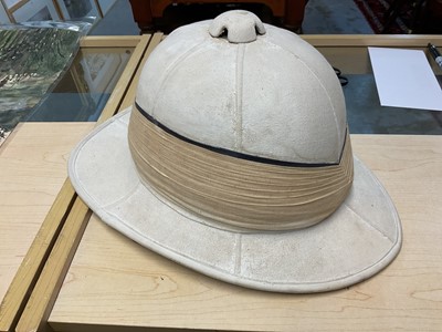 Lot 112 - Early 20th century British Officer's Wolseley pattern pith helmet with original silk and leather lining, in a japanned helmet tin.