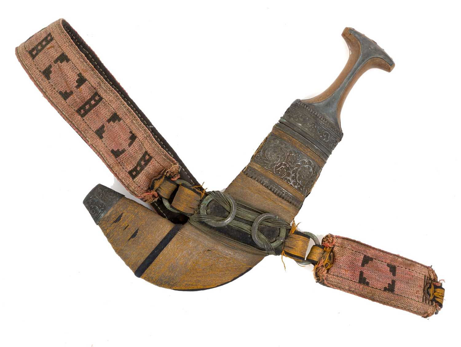 Lot 147 - Early 20th century Arab Jambia dagger with silver mounts and horn grip, curved blade with central rib, in original sheath with woven belt.