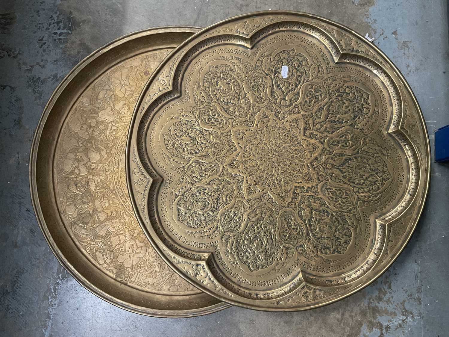 Lot 205 - Two large Persian embossed brass chargers, 58cm diameter