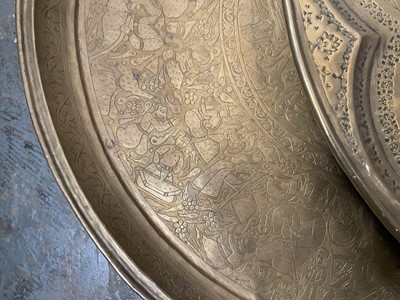 Lot 205 - Two large Persian embossed brass chargers, 58cm diameter