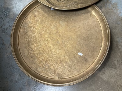 Lot 205 - Two large Persian embossed brass chargers, 58cm diameter