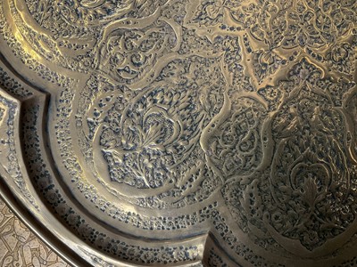 Lot 205 - Two large Persian embossed brass chargers, 58cm diameter