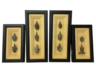 Lot 1111 - Collection of ten ancient Thai fragmentary bronze heads in four frames