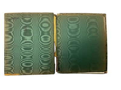 Lot 419 - Victorian silver desk blotter by William Comyns, decorated in relief with winged cherubs