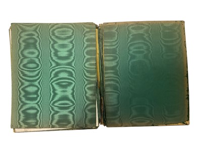 Lot 419 - Victorian silver desk blotter by William Comyns, decorated in relief with winged cherubs