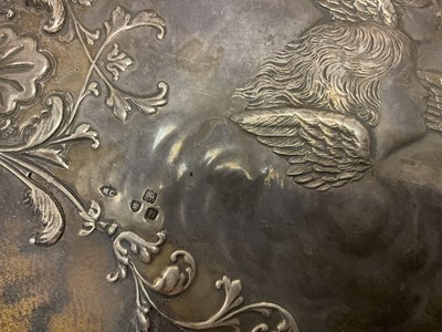 Lot 419 - Victorian silver desk blotter by William Comyns, decorated in relief with winged cherubs