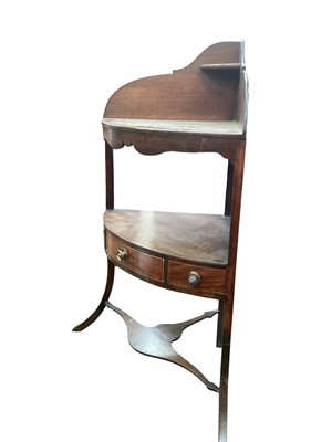 Lot 1243 - George III mahogany corner washstand with arched ledge back