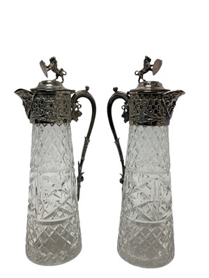 Lot 591 - Pair of post war moulded glass claret jugs with ornate silver plated mounts and lion finials