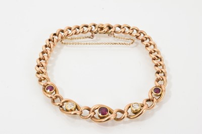 Lot 748 - Edwardian gold curb link bracelet with three rubies and diamonds