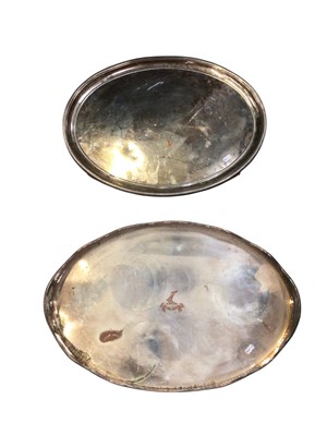 Lot 724 - Plated oval galleried tray with engraved crest and another plated tray of oval form, on ball feet (2)