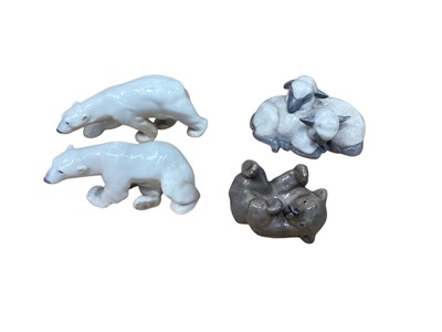 Lot 937 - Royal Copenhagen porcelain model of a pair of sleeping lambs, no. 2769, together with a young bear, no. 1124 and two Bing & Grondahl polar bears (4)