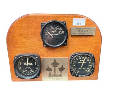 Lot 655 - Group of three Second World War era aircraft cockpit instruments, to include fuel gauge and rev counter, mounted in a wooden display surround.