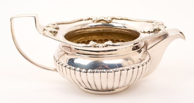 Lot 425 - George III silver cream jug of half fluted form, with shell and gadrooned border