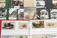 Lot 2564 - PostCarsds in three albums - including real...