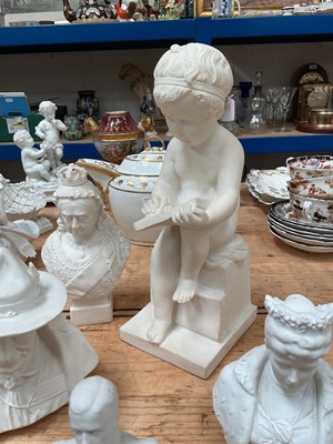 Lot 24 - Plaster figure of a child writing, together with a Coalport bust of Baden-Powell, and Parian ware busts of Queen Victorian, Queen Mary, and King George V (5)