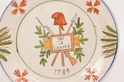 Lot 31 - Two French faience plates, one with Revolutionary decoration and the date 1789