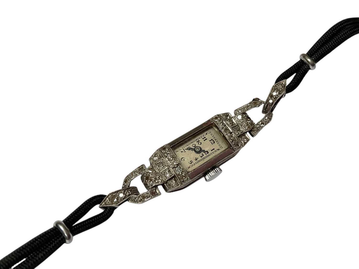 Lot 95 - Art Deco diamond set cocktail watch on black cord bracelet, in box