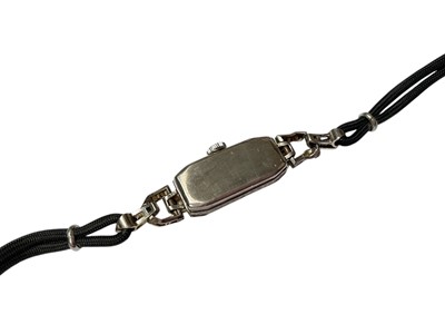 Lot 95 - Art Deco diamond set cocktail watch on black cord bracelet, in box
