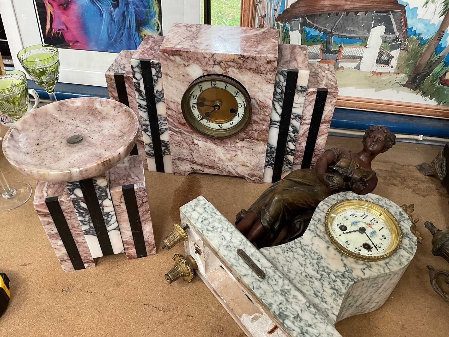 Lot 91 - Large Art Deco marble stepped mantel clock with matching ornament, together with a French spelter figural clock with matching vase (4)