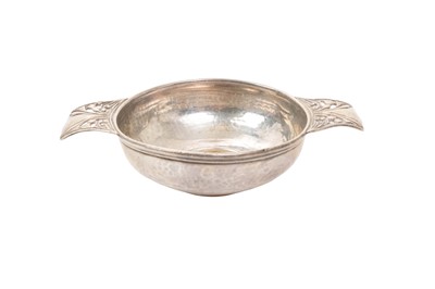 Lot 558 - Silver quaich with hammered finish and pieced thistle decoration to the handles