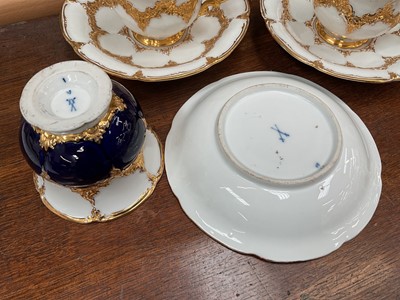 Lot 129 - Three Meissen gilt moulded breakfast cups and saucers, the saucers 15.75cm diameter
