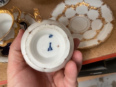 Lot 129 - Three Meissen gilt moulded breakfast cups and saucers, the saucers 15.75cm diameter