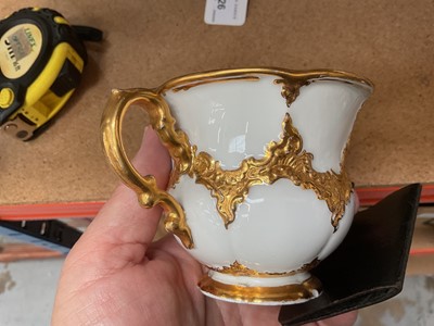 Lot 129 - Three Meissen gilt moulded breakfast cups and saucers, the saucers 15.75cm diameter