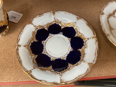 Lot 129 - Three Meissen gilt moulded breakfast cups and saucers, the saucers 15.75cm diameter