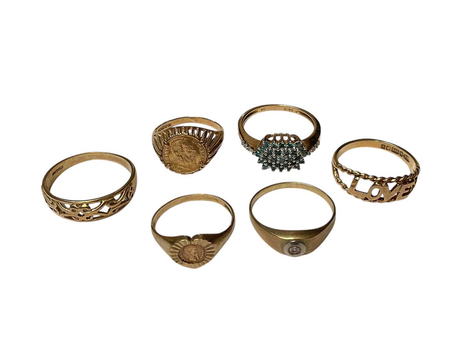 Lot 196 - Six 9ct gold rings to include two set with coins, diamond single stone ring, gem set cluster ring and two rings with pierced bands