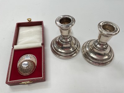 Lot 1027 - Pair of silver dwarf candlesticks (Birmingham 1969) and a contemporary silver caddy spoon in the form of a jockey cap (Sheffield 1993)