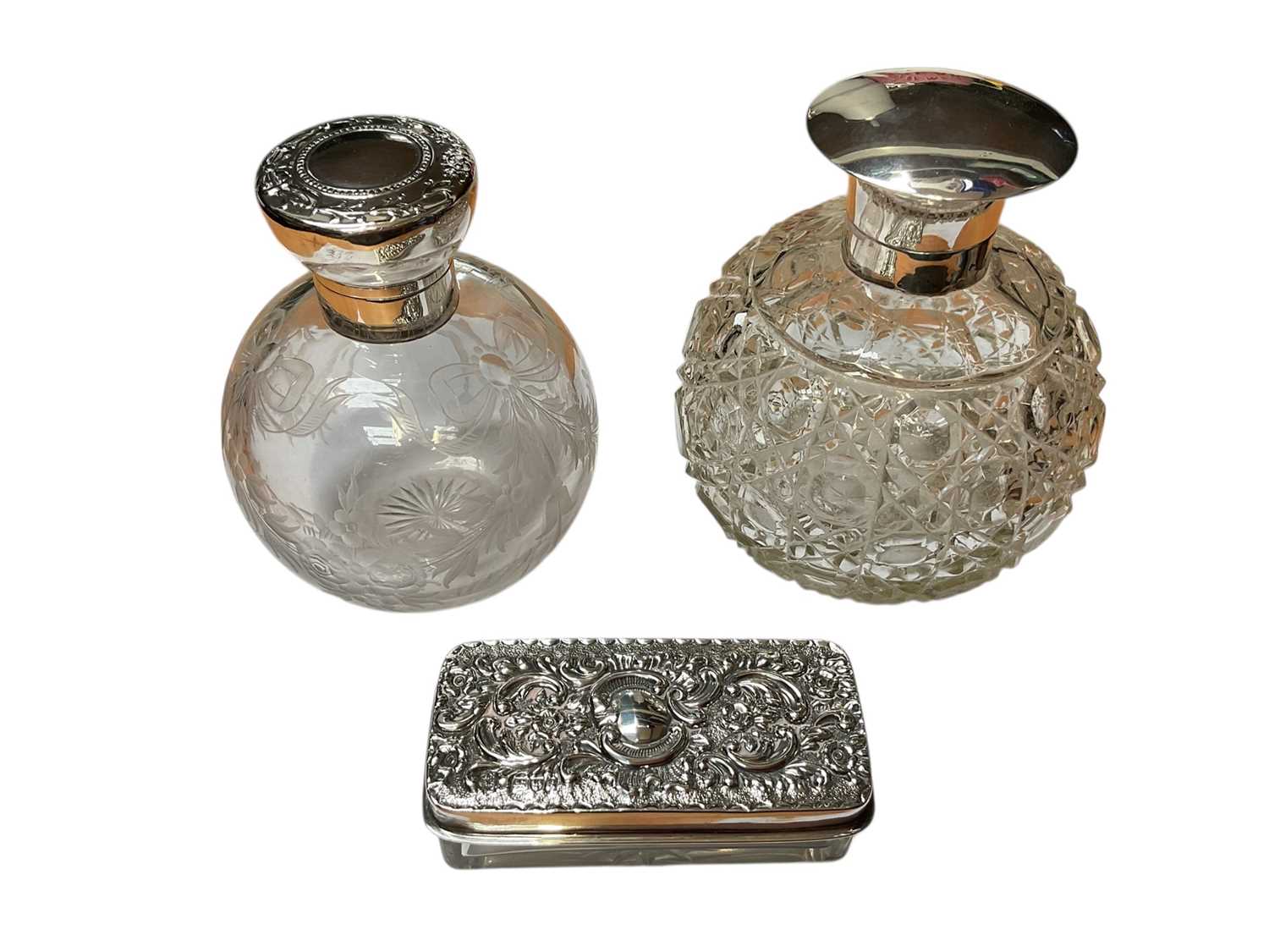 Lot 23 - Edwardian silver mounted glass scent bottle of globular form with engraved floral and ribbon decoration (Birmingham 1906), together with another antique silver mounted glass scent bottle and a s...