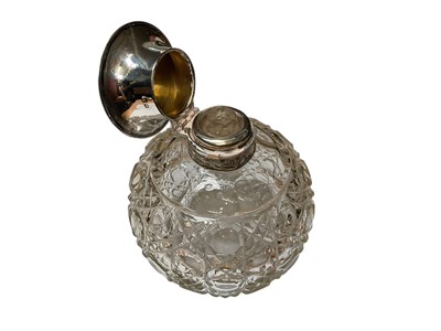 Lot 23 - Edwardian silver mounted glass scent bottle of globular form with engraved floral and ribbon decoration (Birmingham 1906), together with another antique silver mounted glass scent bottle and a s...