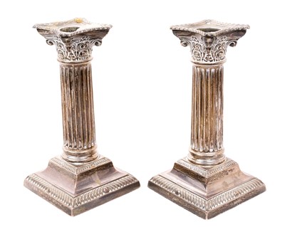 Lot 438 - Pair George V silver Corithian column candlesticks, on square bases with gadrooned borders