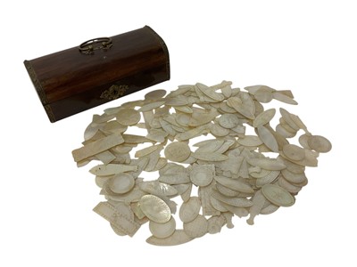 Lot 980 - Large collection of carved mother of pearl gaming counters in domed box